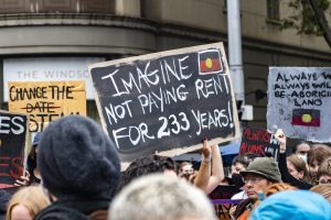 Poster reads Imagine Not Paying Rent for 233 Years